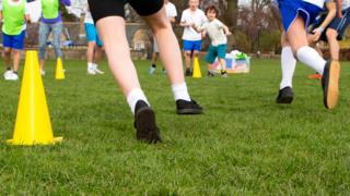 Schoolchildren playing in sports field at school