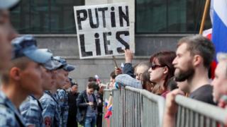 Russia's National Guard watch protesters during the rally