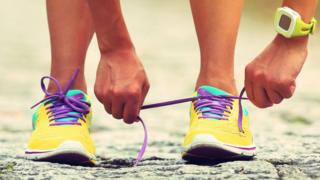 Mujer atándose los zapatos