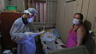 Crew of the emergency medical service SAMU, wearing personal protective equipment (PPE) as a preventive measure against the spread of the novel coronavirus in Brazil