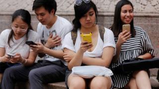 People play Pokemon GO game on their smartphones in New York City, NY on July 13, 2016