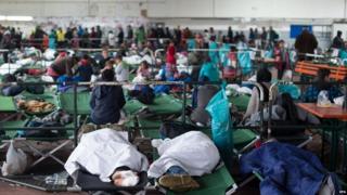 People sleep in an emergency shelter for new arrivals in Passau, southern Germany 30/10/2015