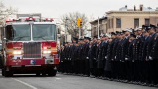 Members of the New York City fire department (FDNY) escort the casket of firefighter Thomas Phelan
