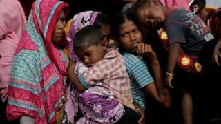Rohingya refugees line up for a food supply distribution at the Kutupalong refugee camp near Cox's Bazar, Bangladesh 12 December 2017.