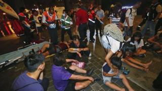 Injured people are helped by emergency rescue workers outside a station after an explosion on a passenger train in Taipei, Taiwan, Thursday, July 7, 2016