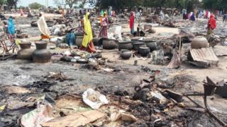 Women sift through the remains of a market blown up during a Boko Haram attack on September 20, 2018, in Amarwa, some 20 kilometres (12 miles) from Borno state capital Maiduguri