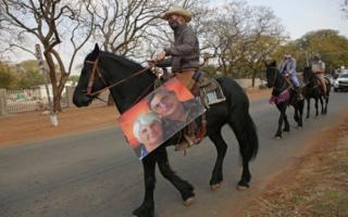 A farmer rides on his horse during a protest against farm attacks in Mookgophong on August 18, 2020.