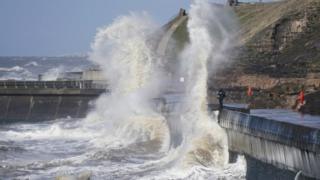 A photographer braves the winds of Storm Gareth and the high tide at Blackpool on March 12, 2019 in Blackpool, United Kingdom. The Met Office has issued yellow warnings as Storm Gareth is forecast to bring potentially disruptive wet and windy weather which could cause travel delays and power cuts.