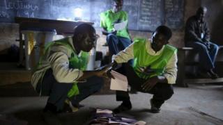 Electoral observers count votes at the end of the presidential and legislative elections, in the mostly muslim PK5 neighbourhood of Bangui