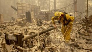 A firefighter examines the wreckage in Berry Creek, California.  Photo: September 12, 2020