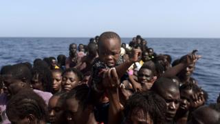 Migrants wait to be rescued by members of Proactiva Open Arms NGO in the Mediterranean Sea, some 12 nautical miles north of Libya, on October 4, 2016.