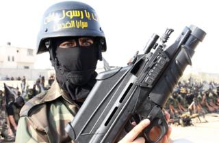 Man holding gun in Gaza parade, 2012