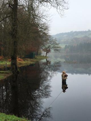 A fisherman standing in water
