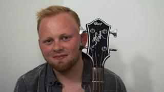 Simon Jones holding a bass