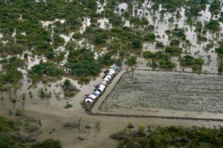 Tents surrounded by water are seen from an aerial view, after heavy rains and floods forced hundreds of thousands of people to leave their homes