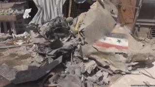 A video purporting to show a crashed Syrian warplane in the town of Ariha