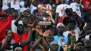 Fans react during a tribute ceremony