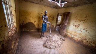 Abdul Mansaray cleaning his house