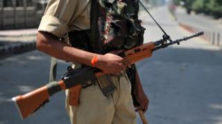 An Indian Central Reserve Police Force (CRPF) officer stands guard, 28 August 2010