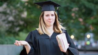 Graduate showing empty purse
