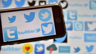 This file photo taken on December 28, 2016 shows logos of US online news and social networking service Twitter