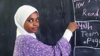Twelve-year-old Alaa writes in English on the blackboard at her school in Sudan's capital, Khartoum.
