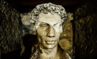 A statue of a man is seen inside the catacombs of Kom El-Shoqafa (Mound of Shards) under Alexandria, Egypt.