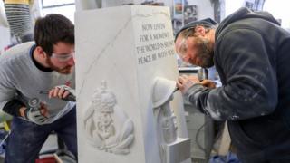 Prisoners carving a war memorial