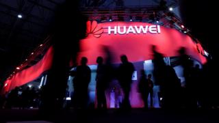 Visitors walk past Huawei"s booth during Mobile World Congress in Barcelona, Spain, February 27, 2017. REUTERS/Eric Gaillard/File Photo