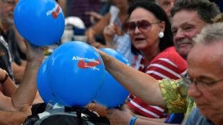 People with balloons attend an election rally of the far-right party Alternative for Germany (AfD) in Koenigs Wusterhausen