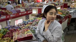 Female worker in Chinese grocery shop