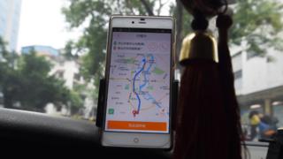 A taxi driver using the Didi Chuxing app in Guilin, China