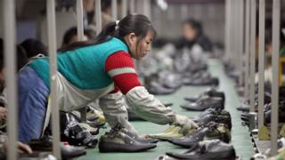 A woman works in a shoe factory in China