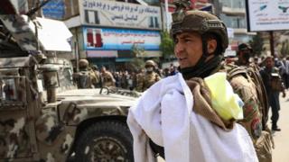 An Afghan soldier transfers a baby to the scene of an attack at the MSF (Doctors Without Borders) hospital in Kabul, Afghanistan, on May 12, 2020.