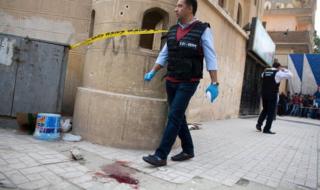 Security officials inspect the damage at Mar Mina church following an attempted attack on the church in the district of Helwan, south-eastern Cairo, Egypt, 29 December 2017