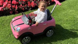 Willow in a Mini pedal car