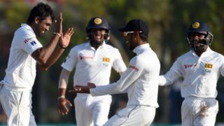 Sri Lanka's Dilruwan Perera (left) celebrates after taking a wicket against Australia