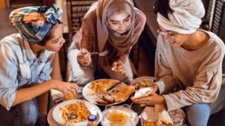 Group of women eating food including chips