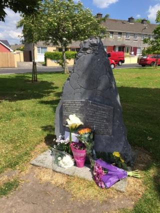 Floral tributes have been laid at the site of Ali's former ancestral home in Ennis