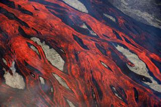 Lava flows ooze over the ground at the Piton de la Fournaise volcano on Reunion.