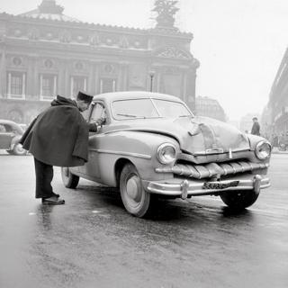 A policeman talks to the driver of a car after an accident