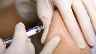 Woman receiving influenza vaccine