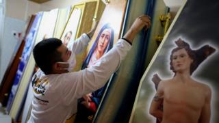 An employee at Viana Funeral services arranges coffins during the coronavirus pandemic in Manaus