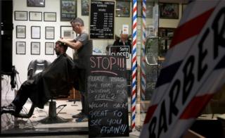 A barber cuts a customer's hair in Christchurch, on 14 May, 2020.