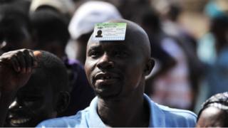 Male voter put im voters card for head.