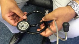 Dr Yemane holding a stethoscope