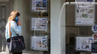 Women looking at estate agent window