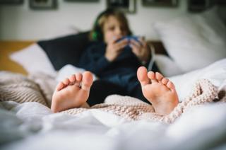 A boy in bed.