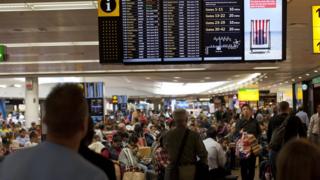 Airline passengers wait for their flight departures July 5, 2012 at London, England's Heathrow Airport in Terminal 3. Tourism in London is expected to surge when the 2012 Summer Olympics begins July 27, 2012. Heathrow is the busiest airport in the United Kingdom and the 4th busiest airport in the world.