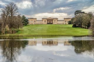 A building reflected in water
